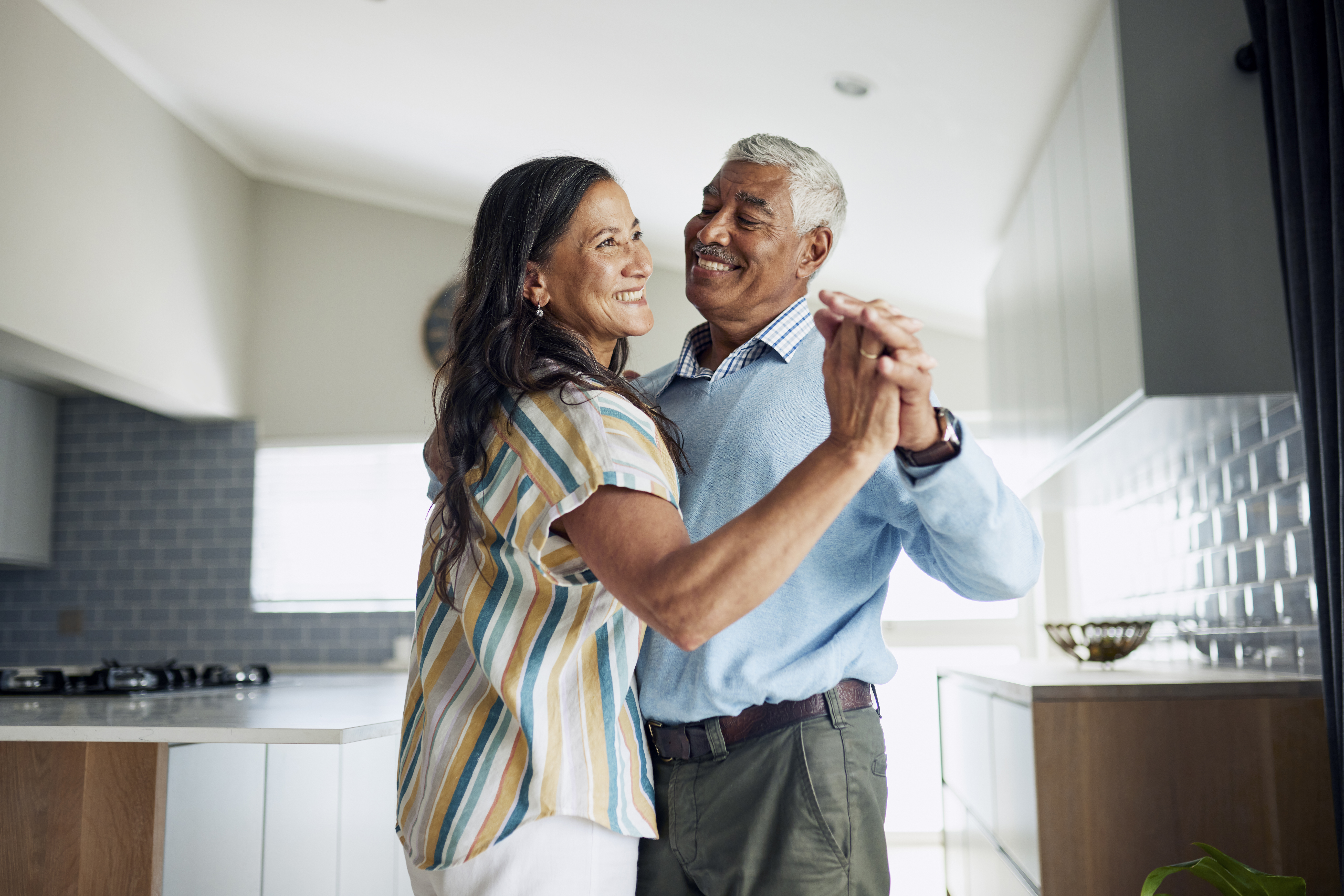 Couple dancing at home after pain relief treatment