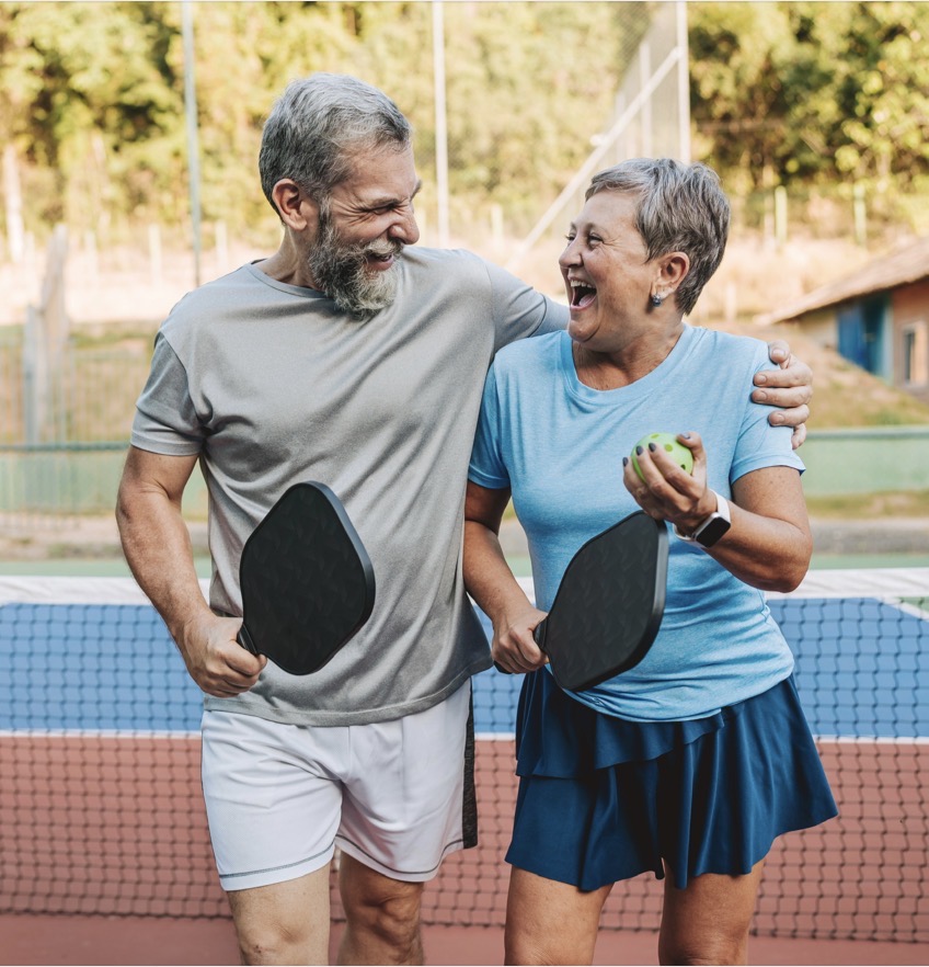 Active couple playing pickleball